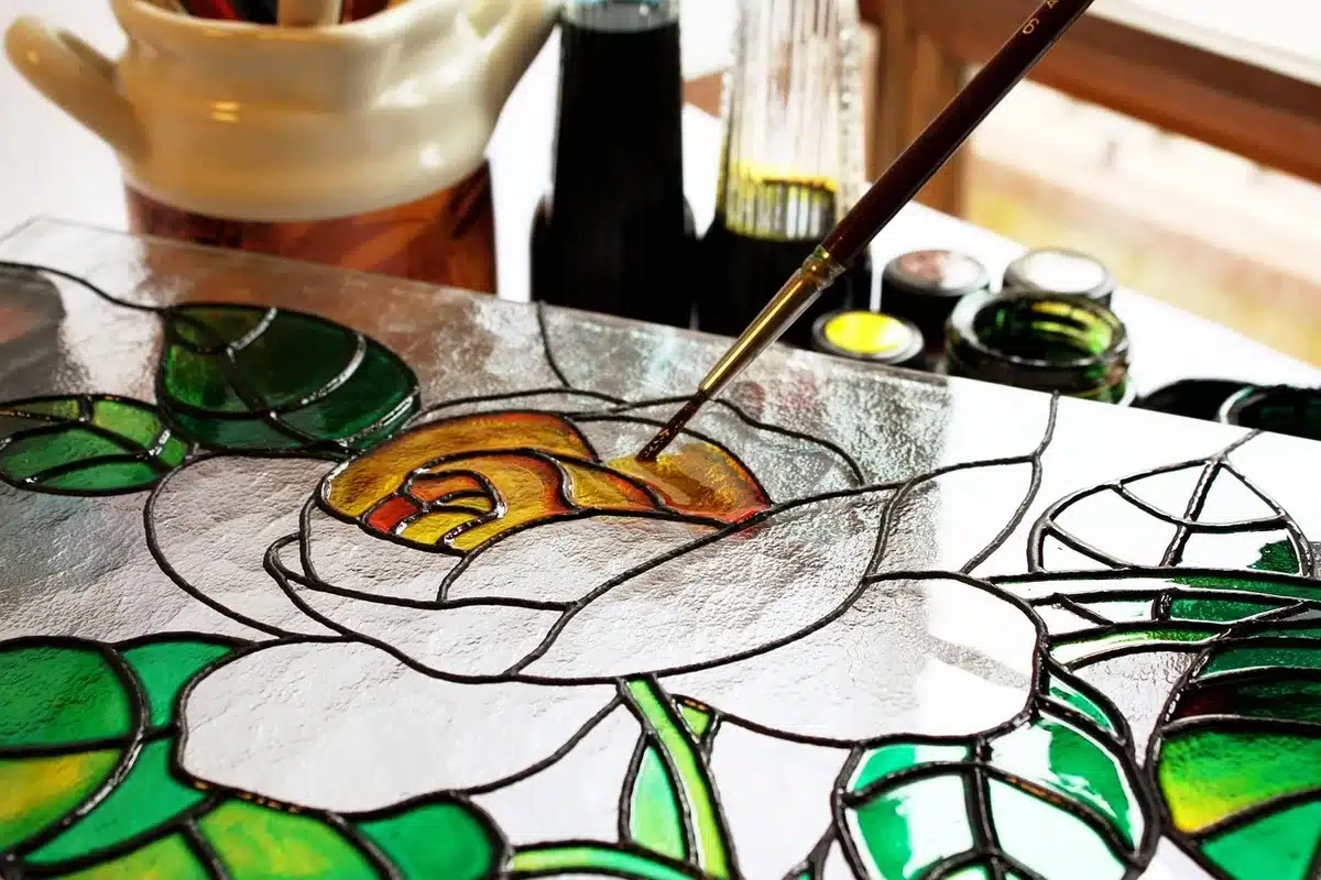 Close-up of stained glass window with abstract modern shapes echoing religious imagery