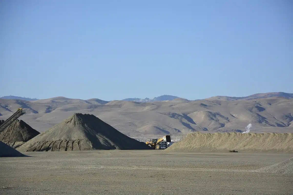 Beach renourishment trucks and exposed seawall accelerating erosion