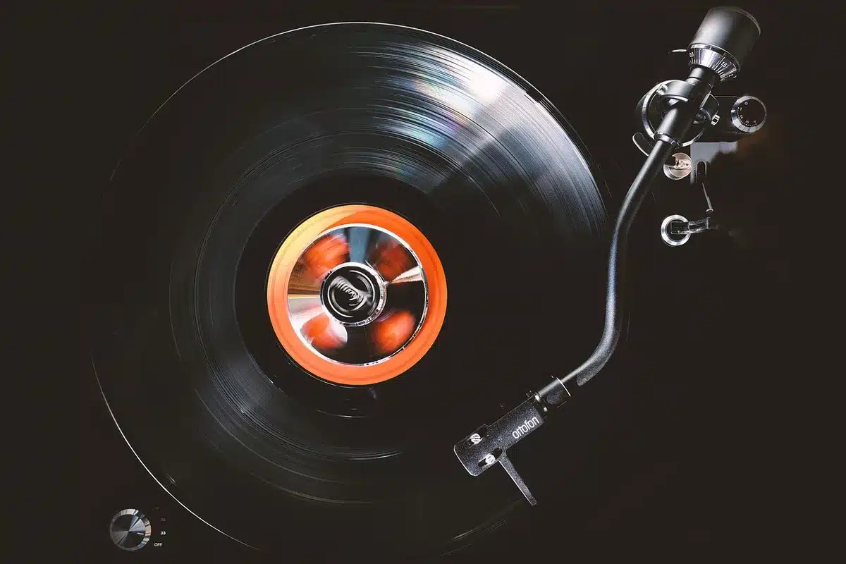 Stack of vinyl records and a record player to show albums aging well
