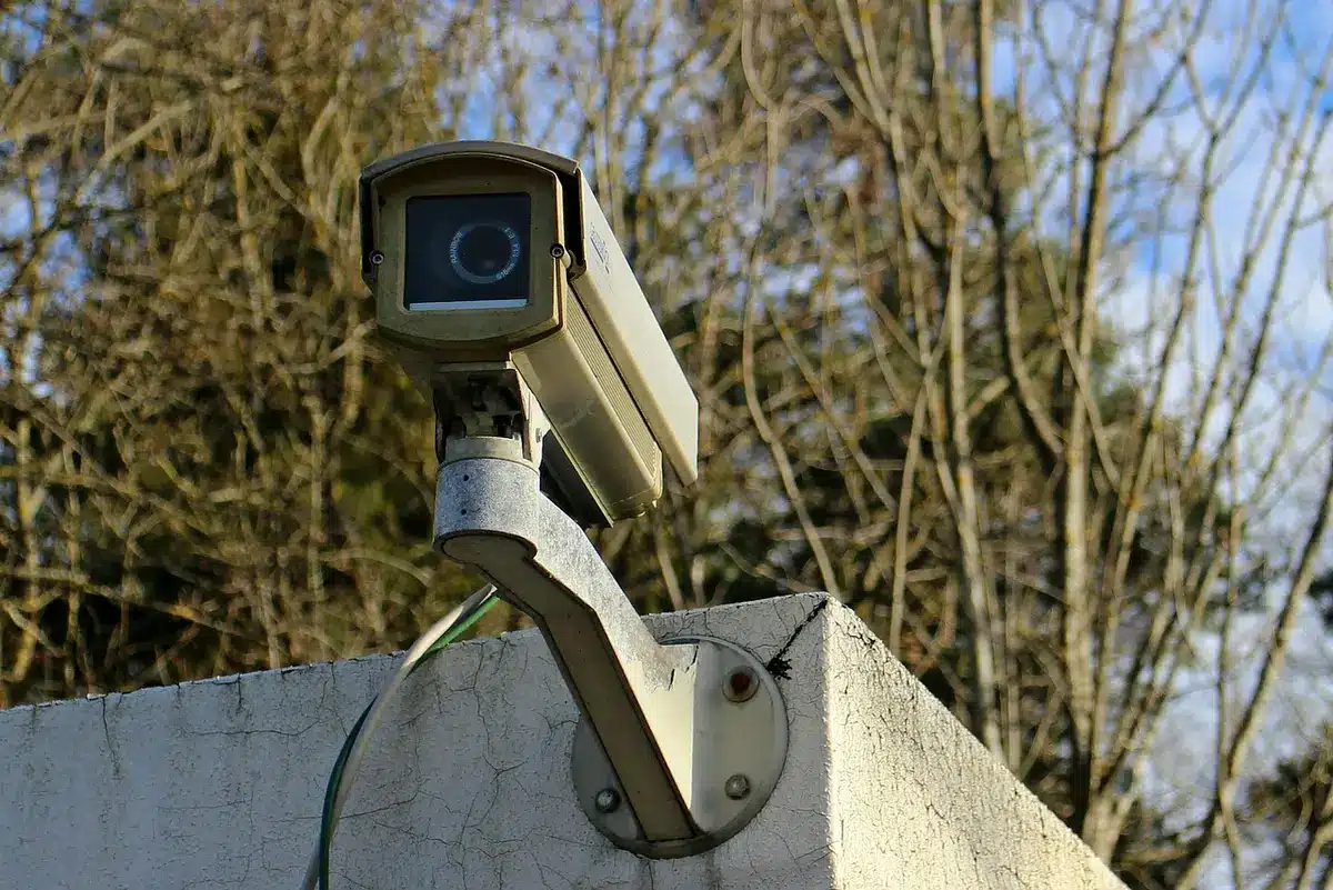 Rows of surveillance monitors in a dim control room