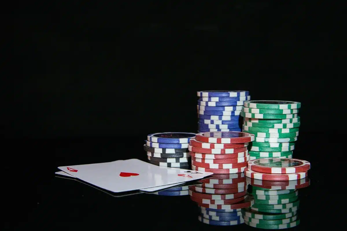 Silhouette near a blackjack table with dealer hands, chips and cards