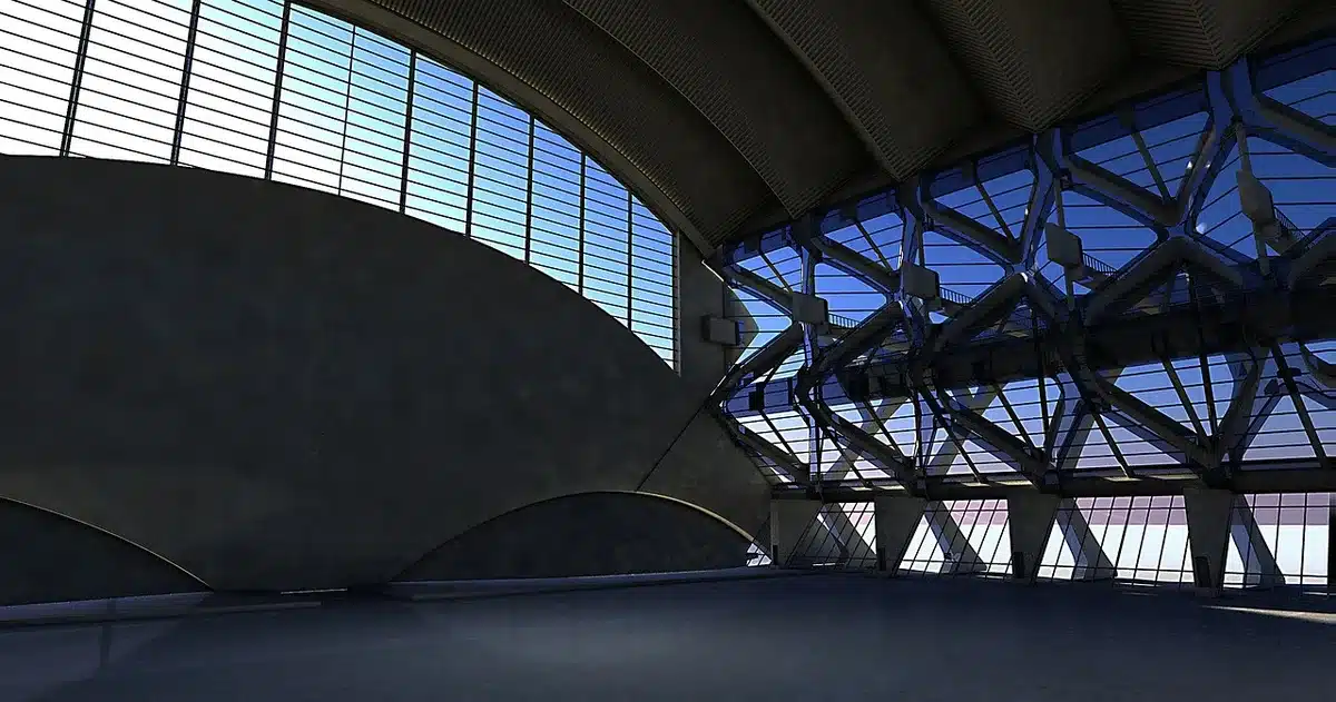 Silhouetted audience watching a giant curved LED screen inside a futuristic arena