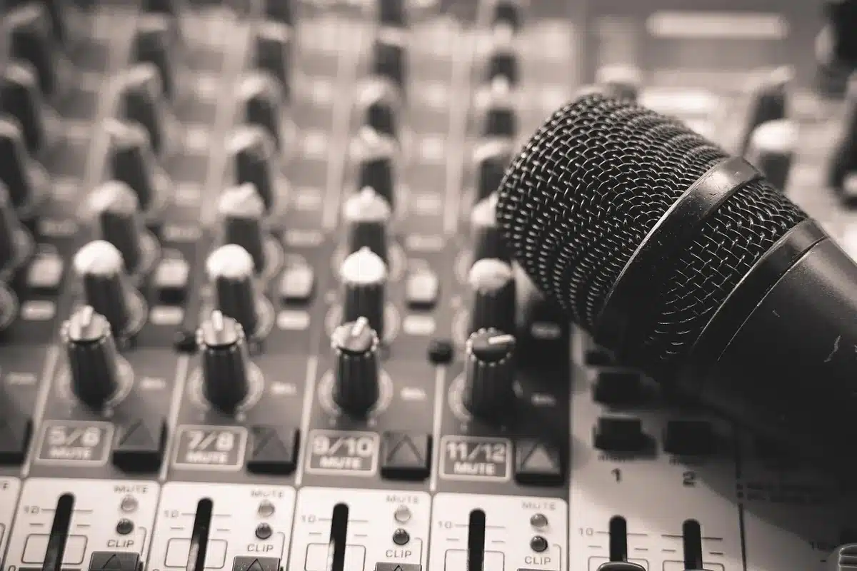 Close-up of a mixing console and producer's hands in a studio