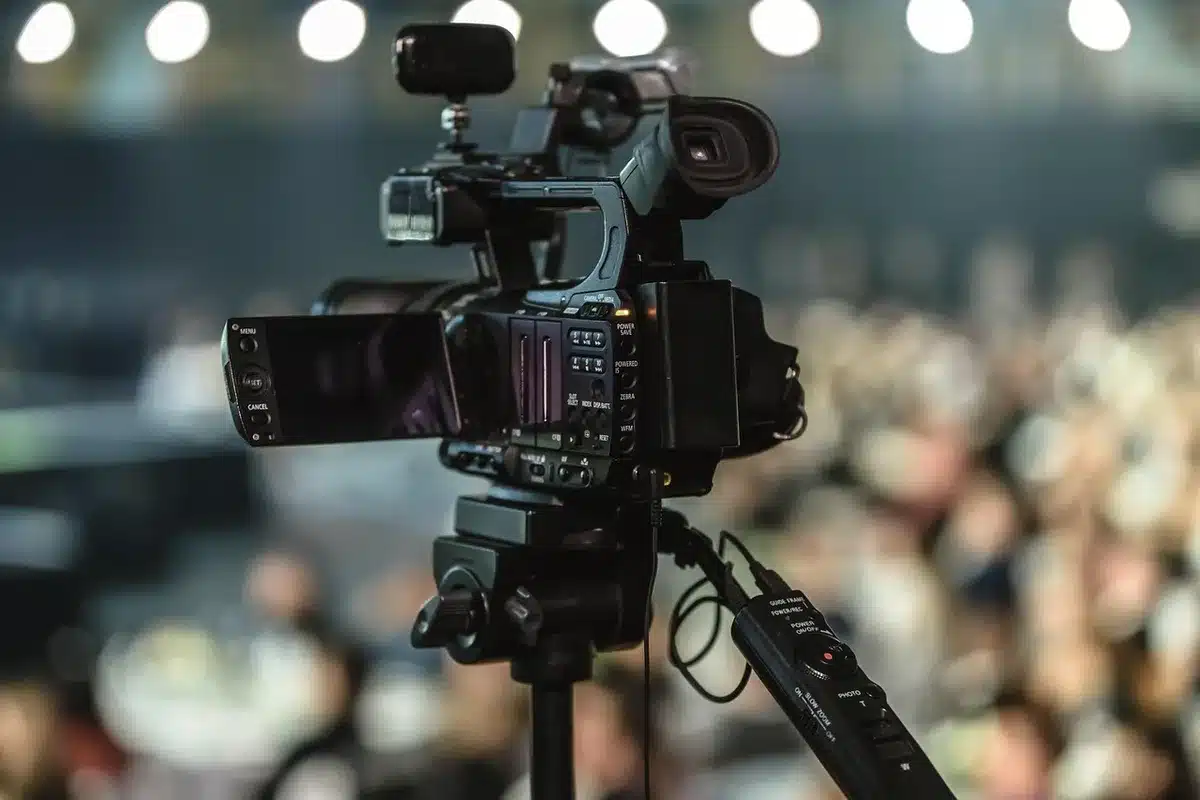 Audience members filming a live performance on smartphones