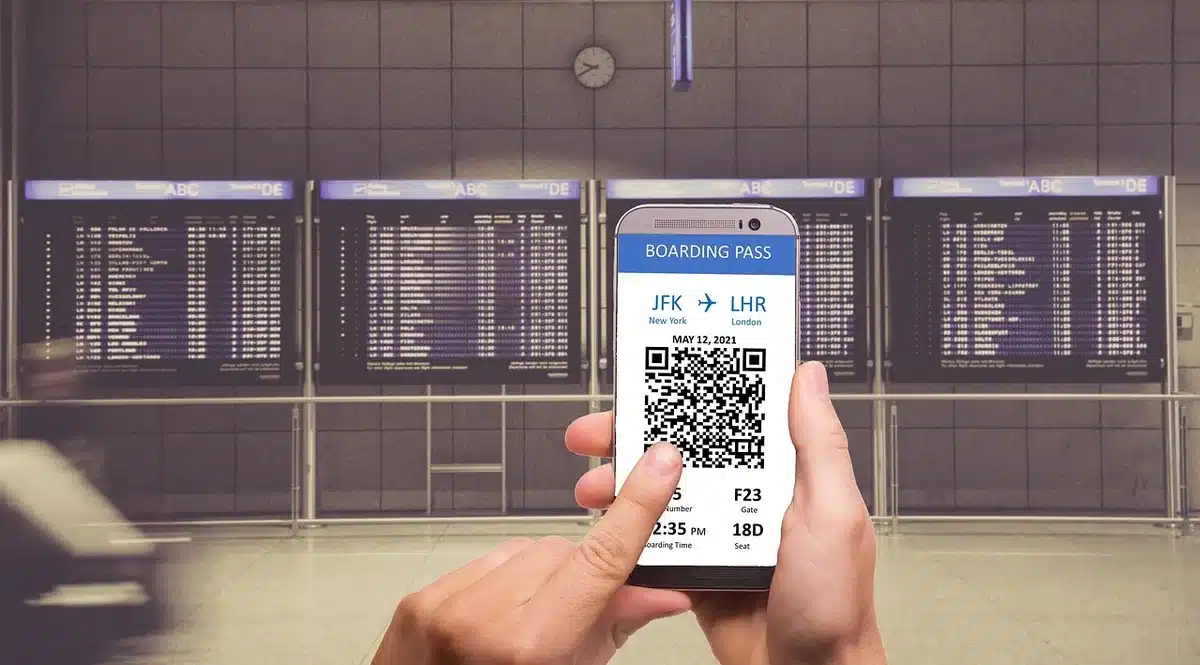 Phone displaying a QR code next to a packed box ready for drop-off