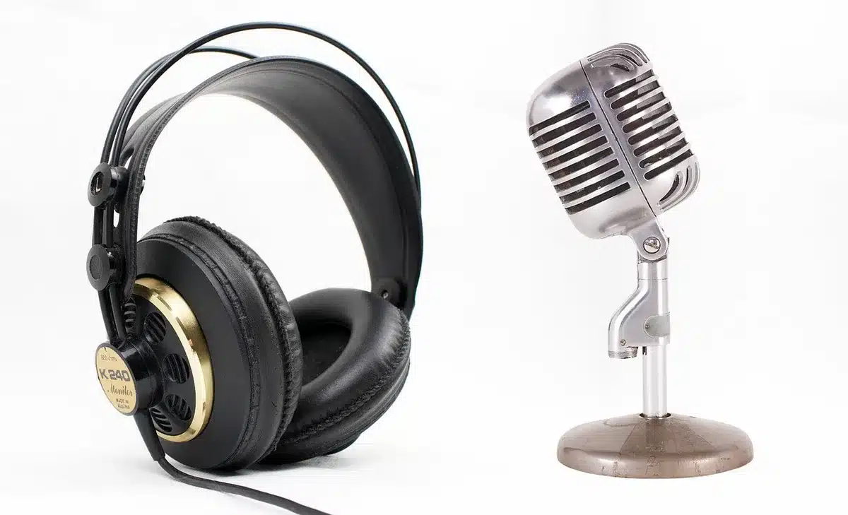 Phone screen showing social feeds with a radio host microphone in background