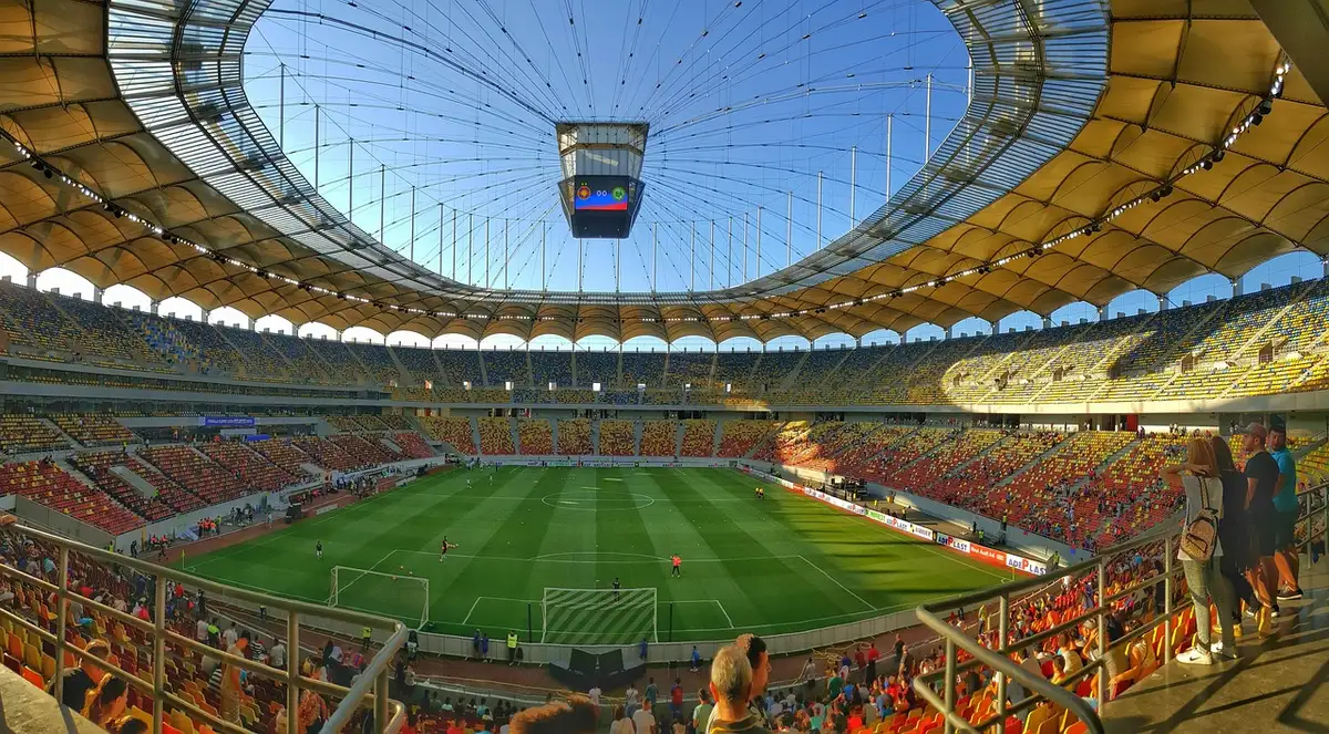 Stadium spectators turning toward a seat as someone enters