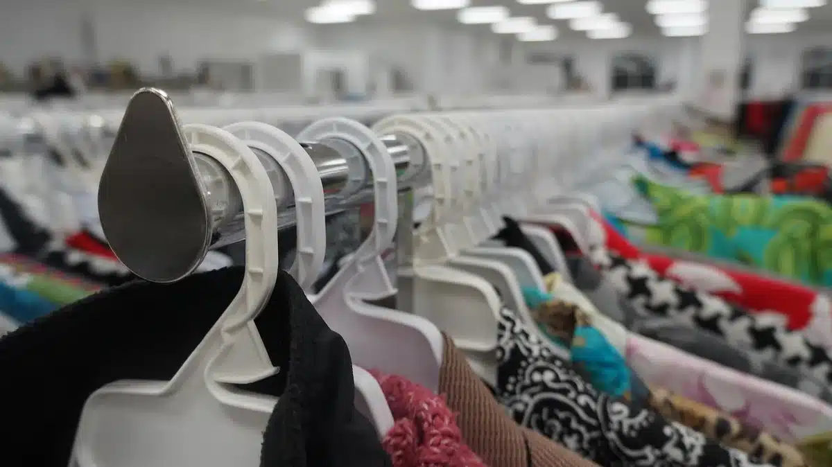 Volunteers folding clothes at a local charity thrift shop counter
