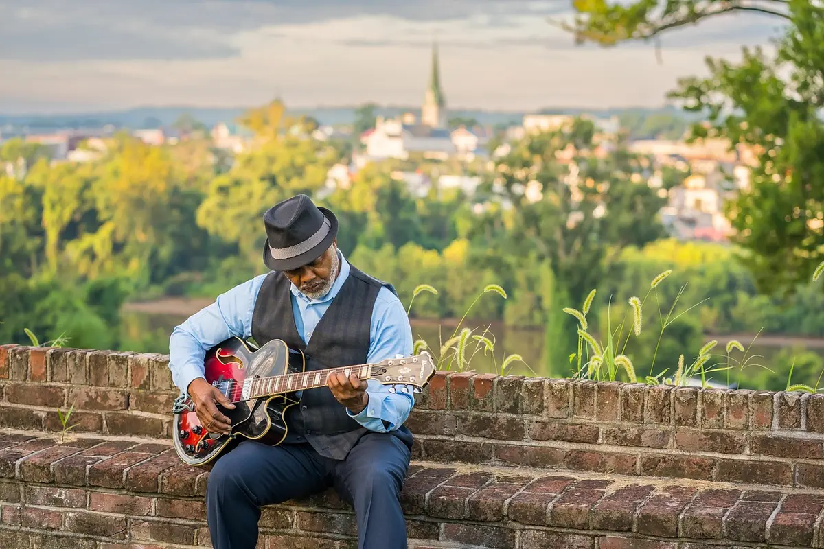 Silhouette of a musician holding a guitar, suggesting a grunge-era voice endorsing a film