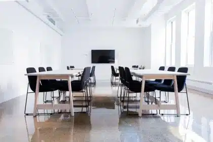 Anonymous aides' hands over smartphones and printed screenshots on a conference table