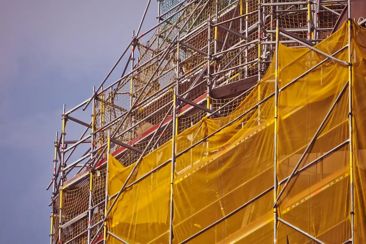 Scaffolding and construction work on a lawn near national monuments