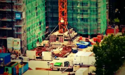 Construction scaffolding and equipment near monuments on a public lawn