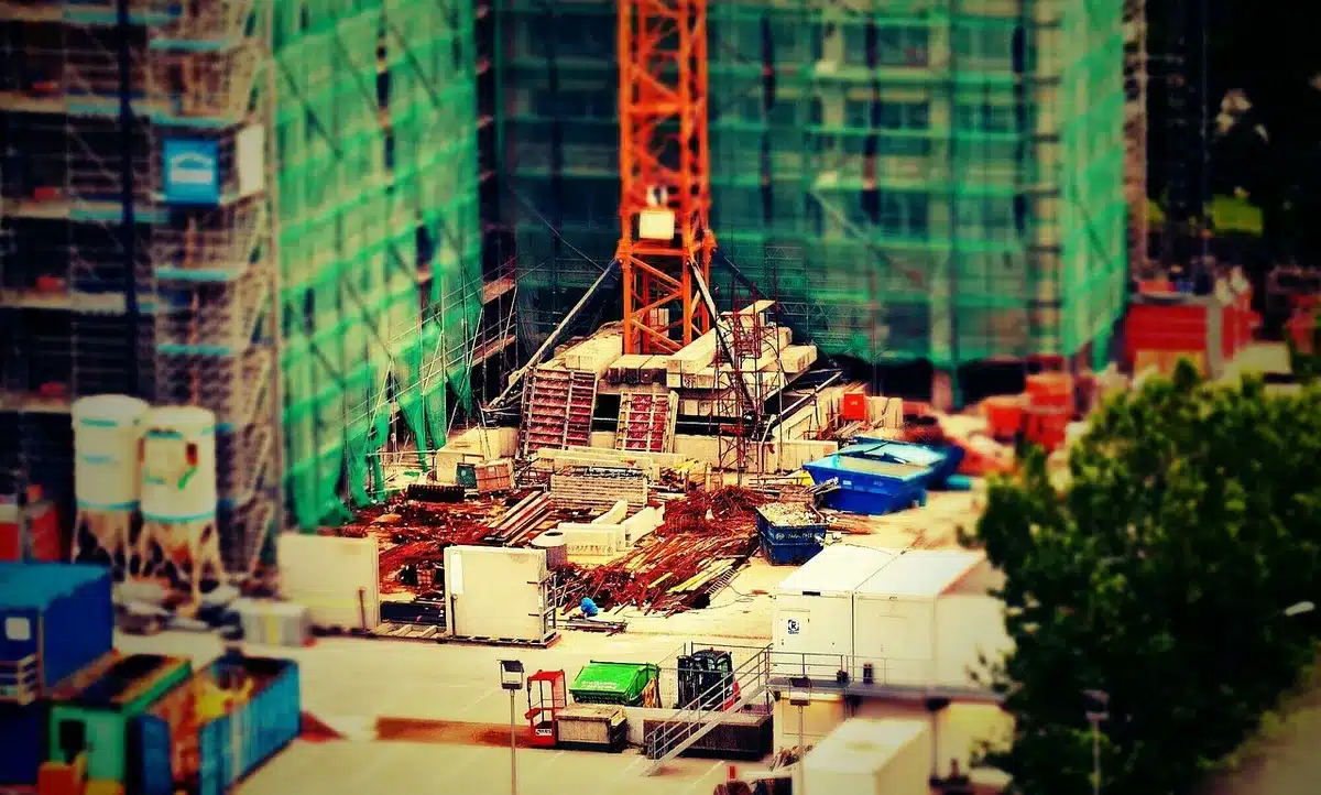 Construction scaffolding and equipment near monuments on a public lawn