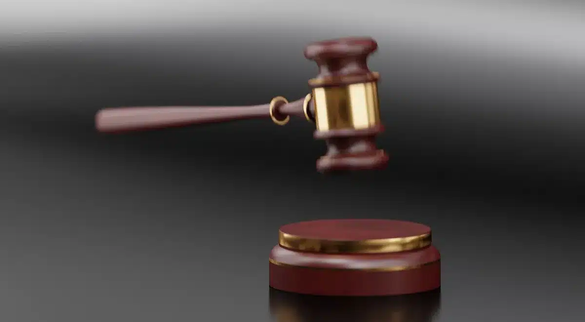 Close-up of a judge's gavel and a courthouse corridor